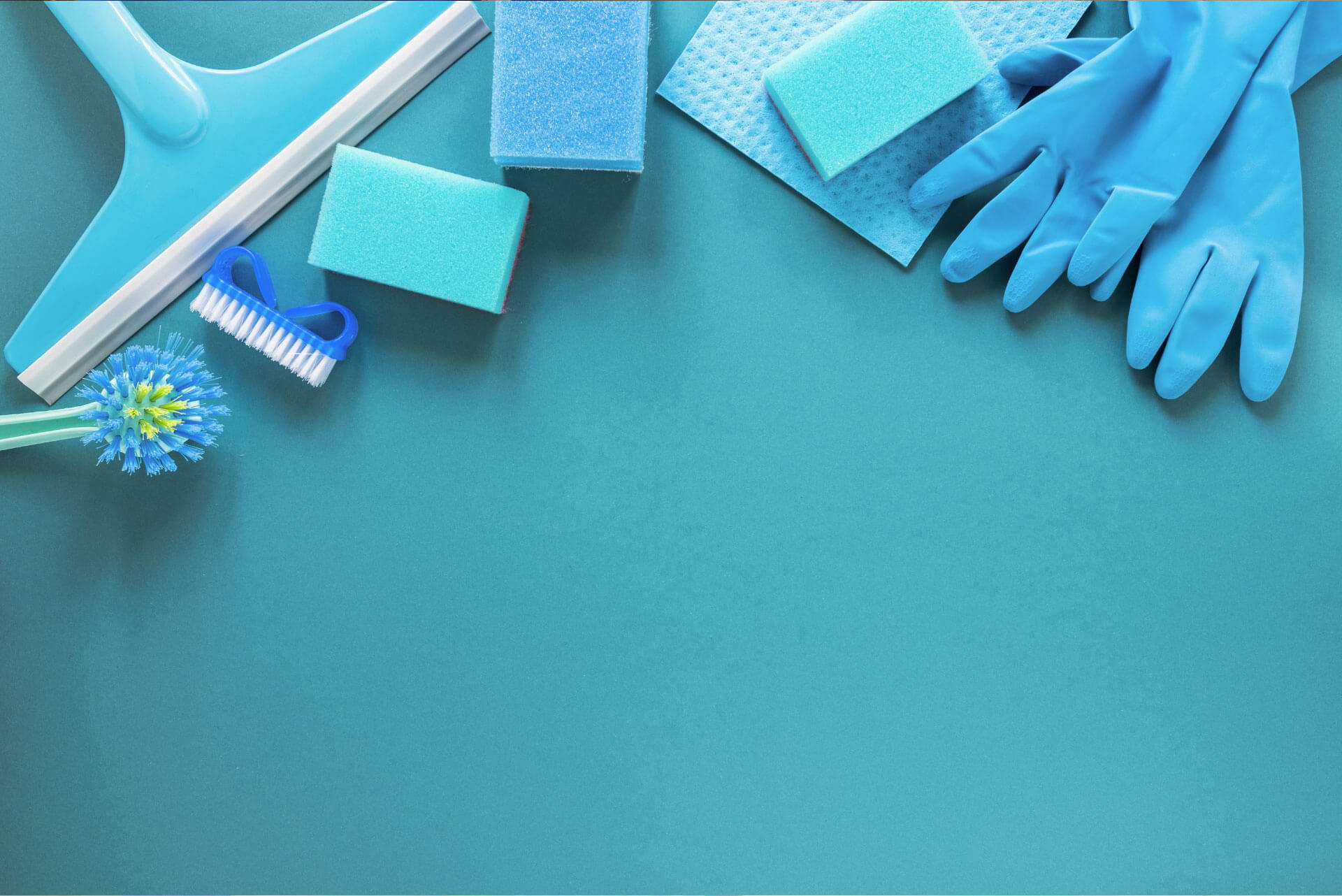 Cleaning supplies with a touch of blue on a turquoise background.