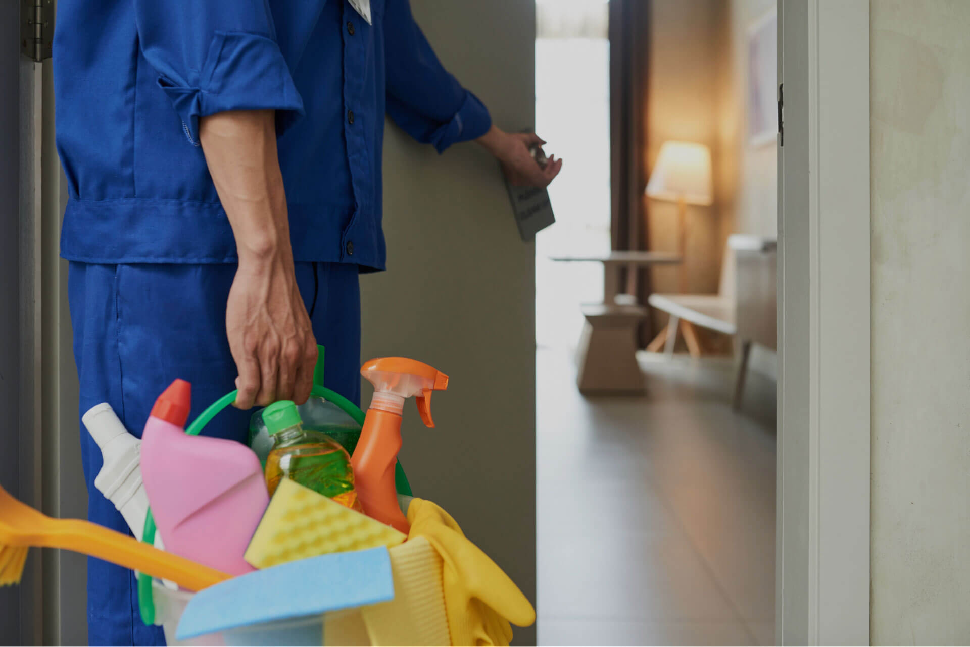 A cleaning maid from Texas holding a bucket of supplies.